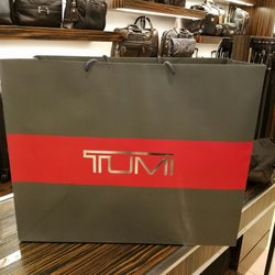 Tumi Store - (",)