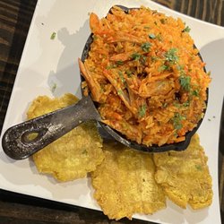 Cali Aji Latin Kitchen and Bakery - Arroz con pollo a chicken and rice dish with tostones/green plantains.