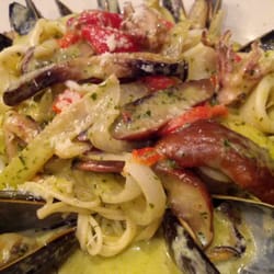 Yummy seafood over angel hair in a pesto sauce!