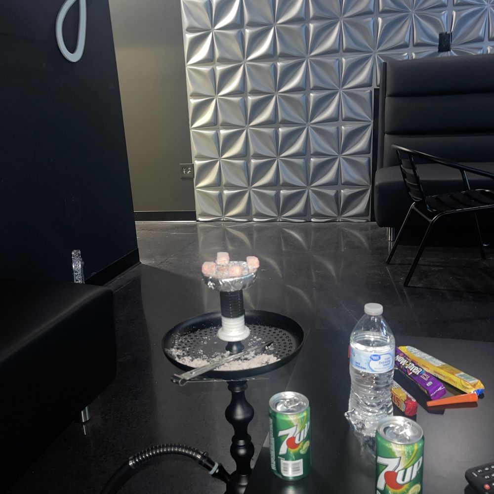 a black table with drinks and snacks on it a black table with drinks and snacks on it