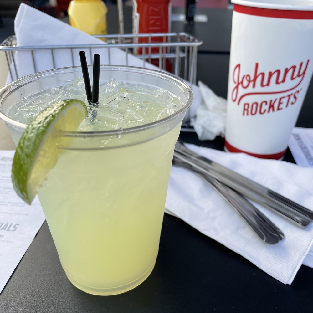 Johnny Rockets - a glass of lemonade with a slice of lime - Burgers Near Me - Queensbury, New York Johnny Rockets - a glass of lemonade with a slice of lime - Burgers Near Me - Queensbury, New York