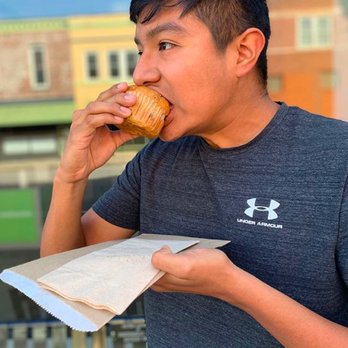A Taste of Independence - a man eating a pastry - Desserts Near Me - Independence, Missouri A Taste of Independence - a man eating a pastry - Desserts Near Me - Independence, Missouri