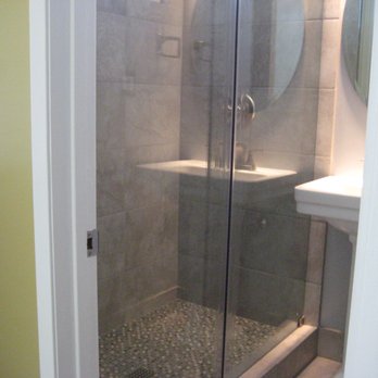 James Groff Tile and Stone - Bathroom remodel San Diego, CA. Porcelain tile shower, sliding glass door, pedistal sink, oval mirror, - General Contractors Near Me - Santee, California