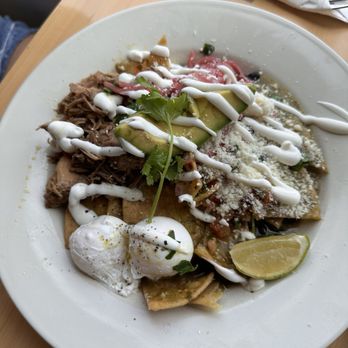 Madi - Chiliquilles con carnitas and poached eggs. My daughter enjoyed them!! They Crispy not soggy perfect!! 10/10 - Breakfast & Brunch Near Me - San Diego, California