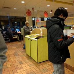 a man standing in a restaurant a man standing in a restaurant
