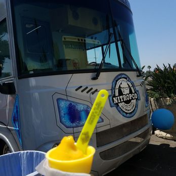 Nitropod - a person holding a cup of ice cream in front of a bus - Ice Cream & Frozen Yogurt Near Me - Los Angeles, California