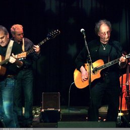 two men playing guitar and cello