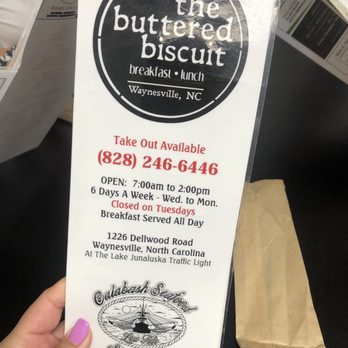 Buttered Biscuit - a hand holding a sign - Breakfast & Brunch Near Me - Waynesville, North Carolina Buttered Biscuit - a hand holding a sign - Breakfast & Brunch Near Me - Waynesville, North Carolina