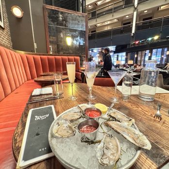 Roxy Bar - Wide shot of oysters, drinks, the bar and cabanas above the balcony. - Bars Near Me - New York, New York Roxy Bar - Wide shot of oysters, drinks, the bar and cabanas above the balcony. - Bars Near Me - New York, New York