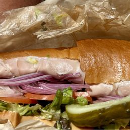 Italian sub and great pickle on the side Italian sub and great pickle on the side