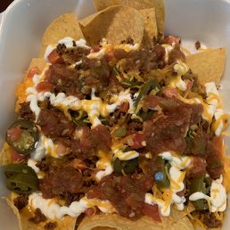 Nachos Supreme, no lettuce, add jalapeños and hot sauce.