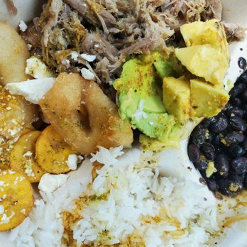 Ally's Cocina - Slow roasted pork with rice, black beans, avocado, fried plantains, delicious fried mini arepas, feta cheese, & Ally's sauce medium. - Venezuelan Near Me - Kilauea, Hawaii Ally's Cocina - Slow roasted pork with rice, black beans, avocado, fried plantains, delicious fried mini arepas, feta cheese, & Ally's sauce medium. - Venezuelan Near Me - Kilauea, Hawaii