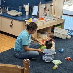 Sunrise Preschools - Playtime is learning time! Teachers and kids bond over toys, sparking creativity and problem-solving together.