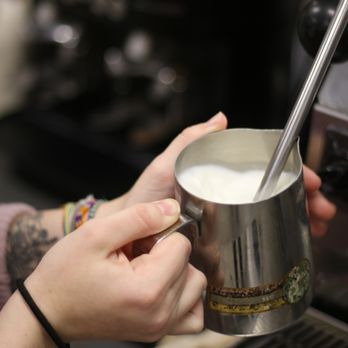 Sidecar Coffee Grand Crossing - a person pouring milk into a cup - Coffee & Tea Near Me - Waterloo, Iowa Sidecar Coffee Grand Crossing - a person pouring milk into a cup - Coffee & Tea Near Me - Waterloo, Iowa