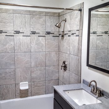 CK Construction - a bathroom with a sink, shower, and bathtub - General Contractors Near Me