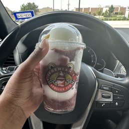 a hand holding a cup of ice cream a hand holding a cup of ice cream