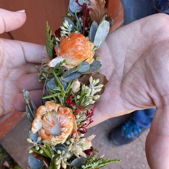 Saffron & Grey - Flowers should be WHITE - Stained orange by the brown leaves used reacting to the water the florist spritzed into the bags. - Florists Near Me - Duluth, Minnesota Saffron & Grey - Flowers should be WHITE - Stained orange by the brown leaves used reacting to the water the florist spritzed into the bags. - Florists Near Me - Duluth, Minnesota