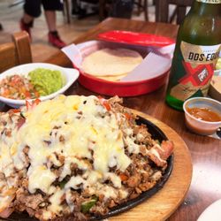 Pork, sausage, red and green peppers, onion and garlic served with choice of flour or corn tortillas and pico de gallo and guacamole.