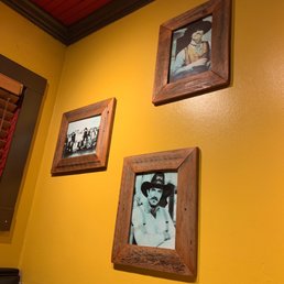 a couple of framed photos on a yellow wall a couple of framed photos on a yellow wall