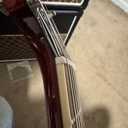 Les Paul with low e string is riding the top of the nut not sitting securely in the slot for the string.