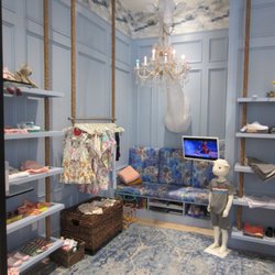 M by Maggie Rizer - Children's shopping nook. Giant giraffe head, chandelier, tv, and large bunnies for fun : )