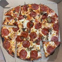 Domino's Pizza - Medium 2 topping pizza (pepperoni and Italian sausage). A little brown on the edges, but not burned because this is a very thin crust pizza.