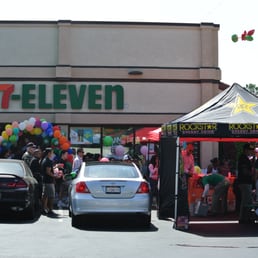 a large group of people standing in front of a store a large group of people standing in front of a store
