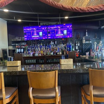 Mijana - a bar with chairs and a television in the background - Mediterranean Near Me - Tempe, Arizona Mijana - a bar with chairs and a television in the background - Mediterranean Near Me - Tempe, Arizona