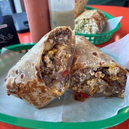 Steak & Eggs breakfast burrito with guacamole and beans and potato's.