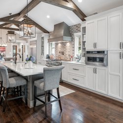 Reico Kitchen & Bath - Ultracraft Cabinetry's Avon door style in Melted Brie with Brown Linen glaze (perimeter) & Coastal Grey (island).