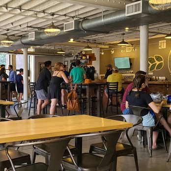 Sisyphus Brewing - a large group of people sitting at tables - Breweries Near Me - Minneapolis, Minnesota