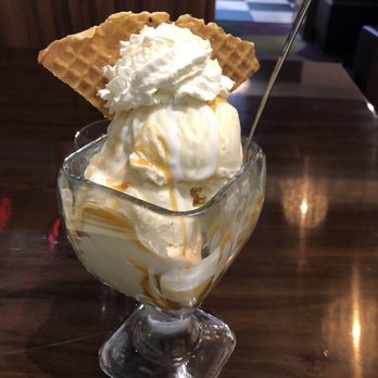 White Rabbit Dessert Experience - Build your own Sundae - Double scoop of vanilla with caramel and marshmallow sauce. Waffle cone garnish - Desserts Near Me - Tonawanda, New York
