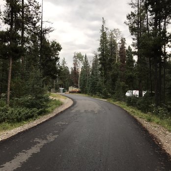 Wabasso Campground - Bathroom & firewood in the distance - Campgrounds Near Me - Jasper, Alberta