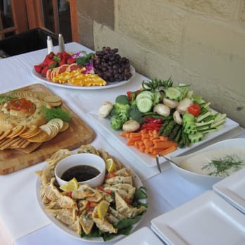 Hannah's Off The Square - Cocktail party food. Baked brie, fresh fruit, vegetables with dip, and potstickers - New American Near Me - Denton, Texas