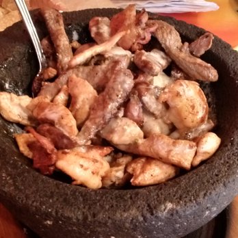 La Hacienda - Molcajete: chicken, shrimp, steak (closer) and Verde Enchaladas with tamale (back) - Mexican Near Me - Fremont, Nebraska