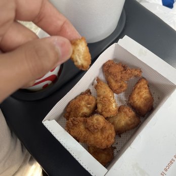 Chick-fil-A - 7 normal sized chicken nuggets / in the box 1 little itty bitty chicken nugget / in my hand - Fast Food Near Me - Corpus Christi, Texas