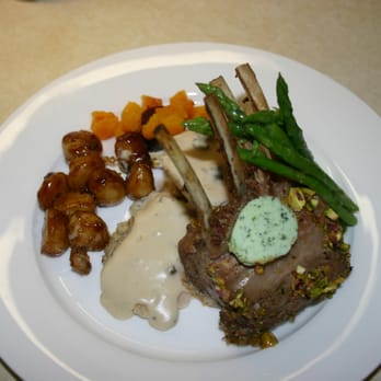Stinson Catering - A rack of Lamb with roasted vegetables, poached asparagus, Parissene potatoes herb butter and mushroom chicken filet. - Caterers Near Me