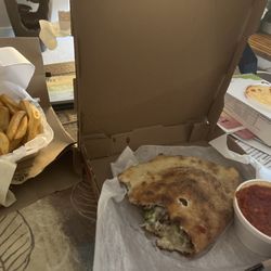 Tolli's Pizzeria & Deli - My lunch . Yummy !! Calzone and fries
