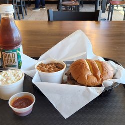 Smokey Jake's BBQ - Sliced smoked brisket sandwich, BBQ beans, cole slaw, & a bottle of sweet tea to soothe the throat.