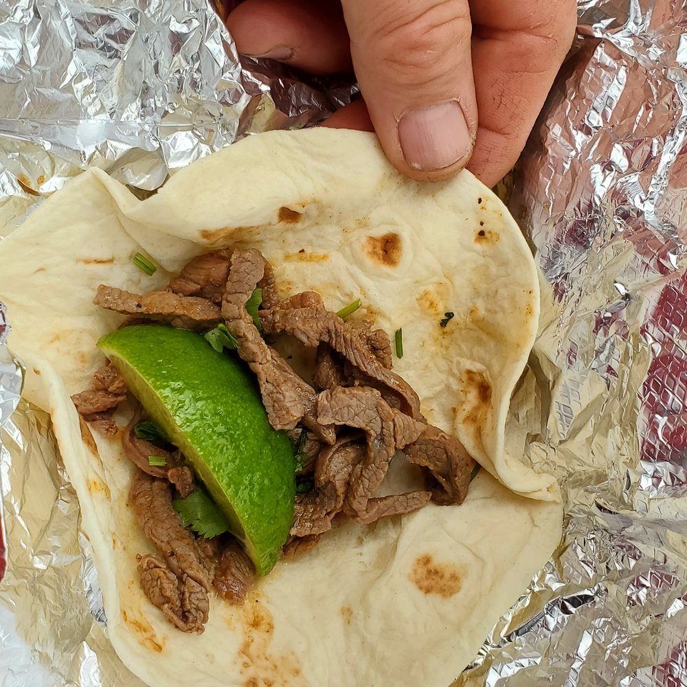 Baja Burrito Co - a hand holding a burrito - Mexican Near Me - Clinton, New Jersey