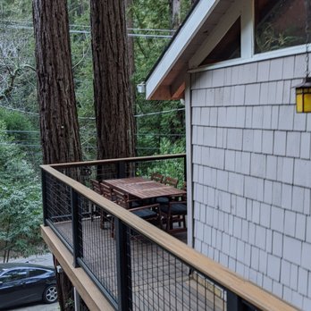 831 Builders - a view of a deck with a table and chairs - General Contractors Near Me