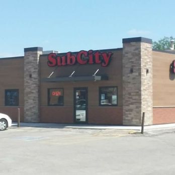 Sub City - a car parked in front of a sub city - Salad Near Me - Waterloo, Iowa