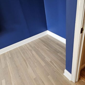 Prospero Home Improvement - a hardwood floor in a blue room - General Contractors Near Me Prospero Home Improvement - a hardwood floor in a blue room - General Contractors Near Me
