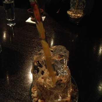 Alinea - Some kind of distilled spices served in a carved ice cup with a glass straw.. - New American Near Me - Chicago, Illinois