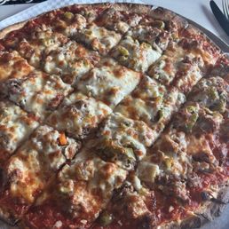 Thin crust pizza with sausage, Italian beef, garlic and hot giardiniera Thin crust pizza with sausage, Italian beef, garlic and hot giardiniera