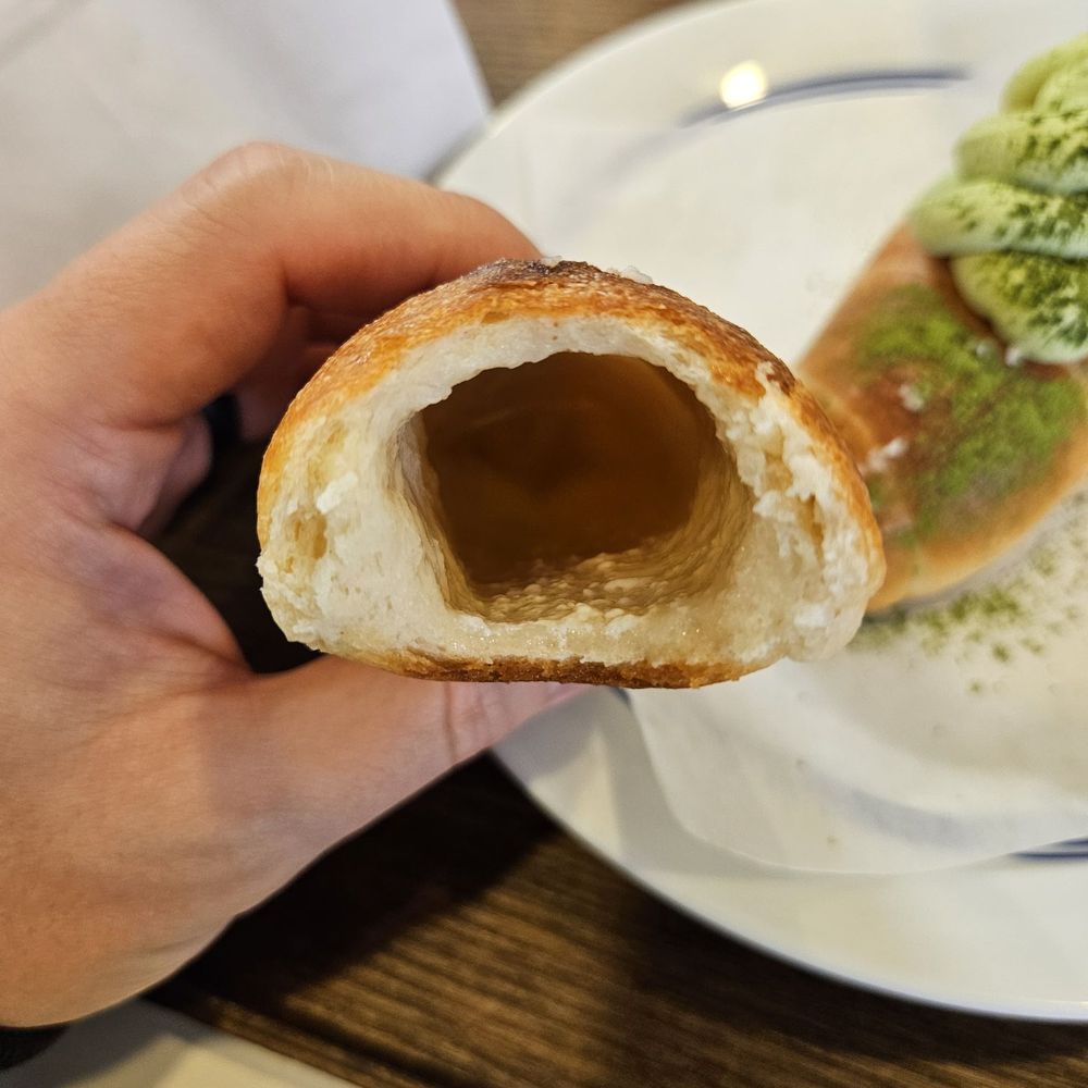 Childish Bakery - Cross-section of salt bread with pool of melted butter at the bottom - Bakeries Near Me - Carrollton, Texas Childish Bakery - Cross-section of salt bread with pool of melted butter at the bottom - Bakeries Near Me - Carrollton, Texas