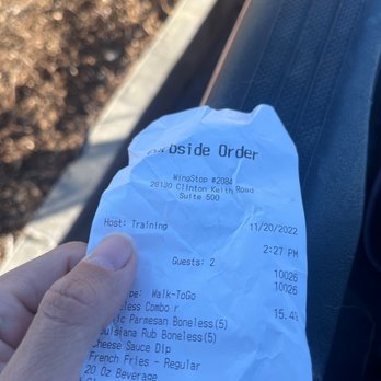 Wingstop - a person's hand holding a receipt - Chicken Wings Near Me - Murrieta, California Wingstop - a person's hand holding a receipt - Chicken Wings Near Me - Murrieta, California