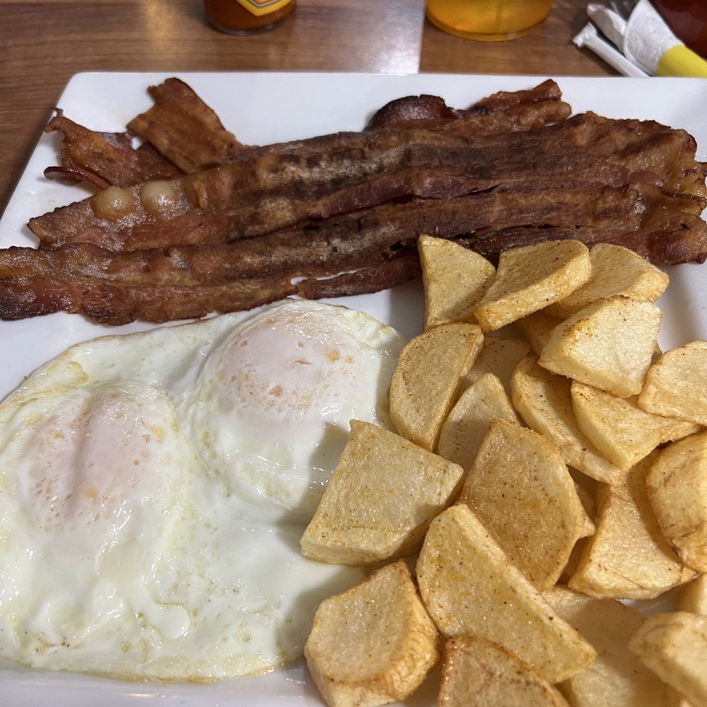 Two eggs, country potatoes, and super crispy bacon Two eggs, country potatoes, and super crispy bacon