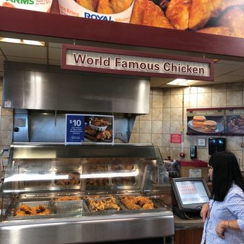 Royal Farms - a woman standing in front of a food counter - Gas Stations Near Me - Dover, Delaware Royal Farms - a woman standing in front of a food counter - Gas Stations Near Me - Dover, Delaware