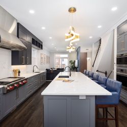 Chi Renovation & Design - Central to the kitchen's allure is a striking aged brass chandelier, suspended with precision above the island.